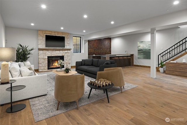 living room with light hardwood / wood-style floors and a fireplace