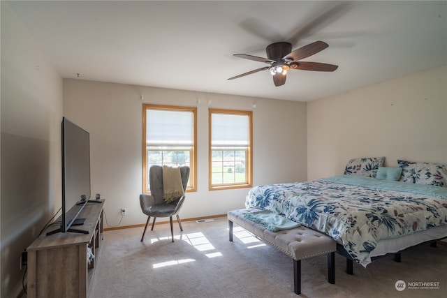 bedroom with light carpet and ceiling fan