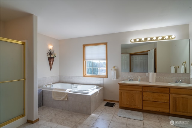 bathroom with independent shower and bath, vanity, and tile patterned flooring