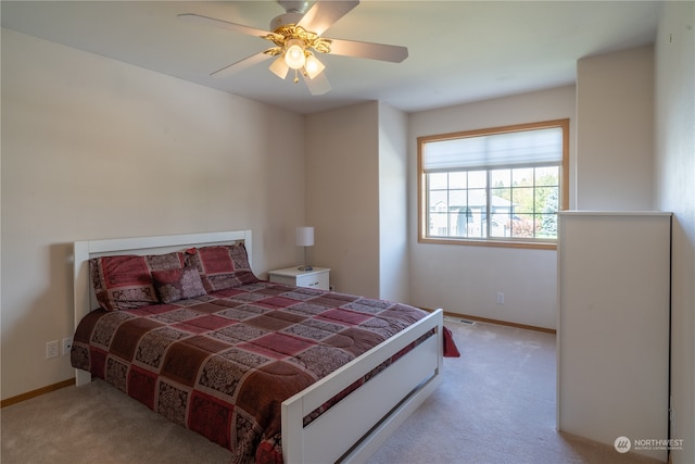 bedroom with ceiling fan and light colored carpet