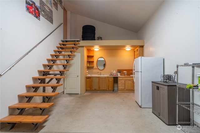 kitchen featuring vaulted ceiling and white refrigerator