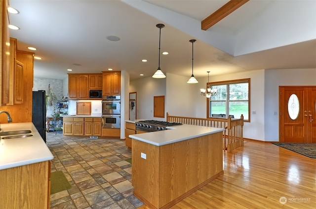 kitchen with a chandelier, a center island, sink, hanging light fixtures, and black appliances