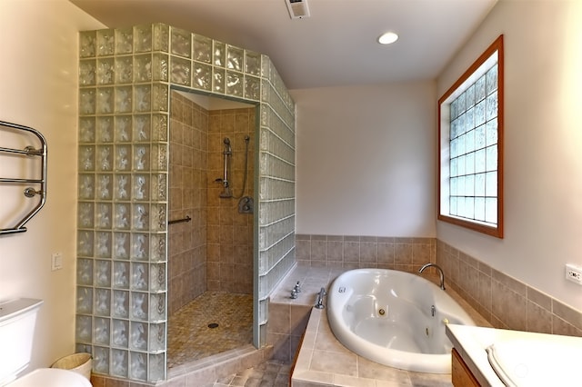 full bathroom featuring independent shower and bath, vanity, and toilet