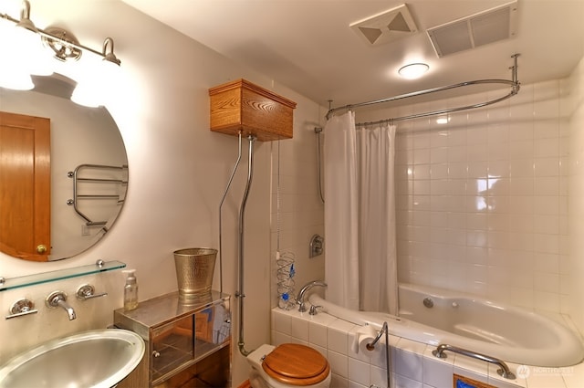 full bathroom featuring shower / tub combo with curtain, toilet, and sink