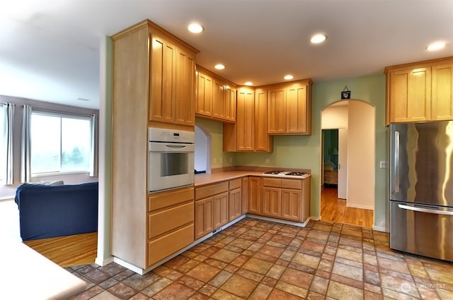 kitchen with white appliances and light brown cabinets