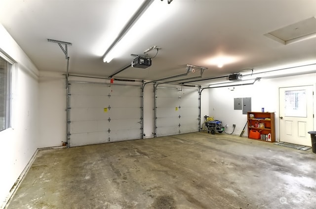 garage featuring electric panel and a garage door opener