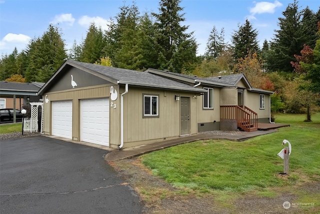 view of front of house with a front lawn and a garage