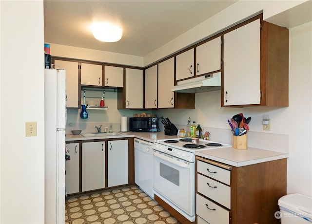 kitchen featuring white appliances, white cabinetry, and sink