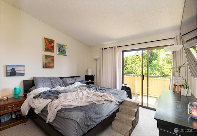 carpeted bedroom with access to outside, a textured ceiling, and lofted ceiling