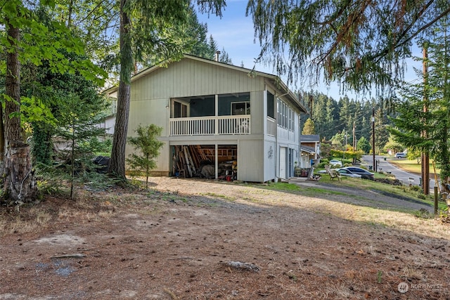 rear view of house featuring a sunroom