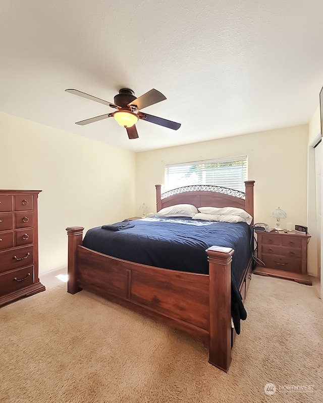 bedroom with light colored carpet and ceiling fan