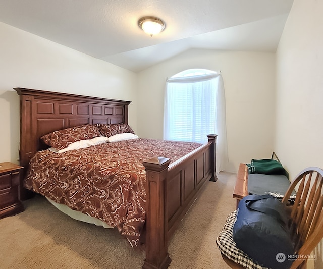 bedroom featuring lofted ceiling and light colored carpet