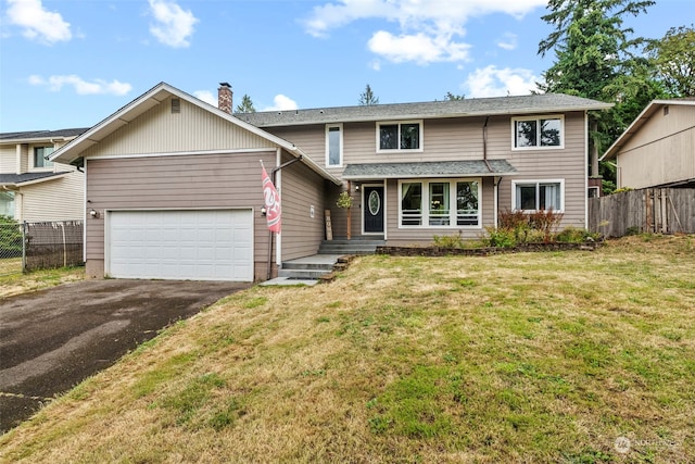 view of front property with a garage and a front lawn