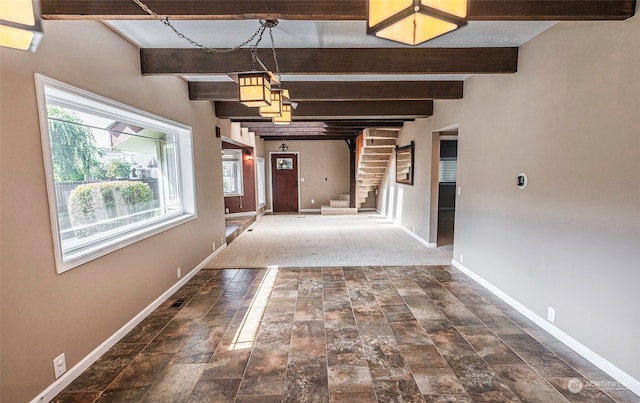 corridor featuring dark carpet and beamed ceiling