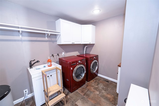 washroom featuring cabinets and washing machine and clothes dryer