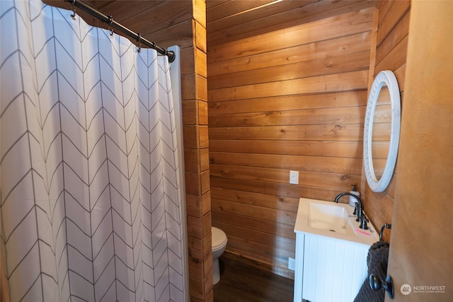 bathroom featuring vanity, wood ceiling, wood walls, walk in shower, and toilet