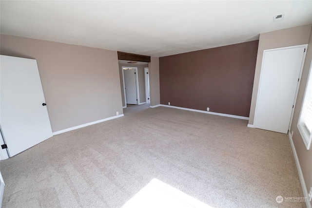 unfurnished room with light colored carpet