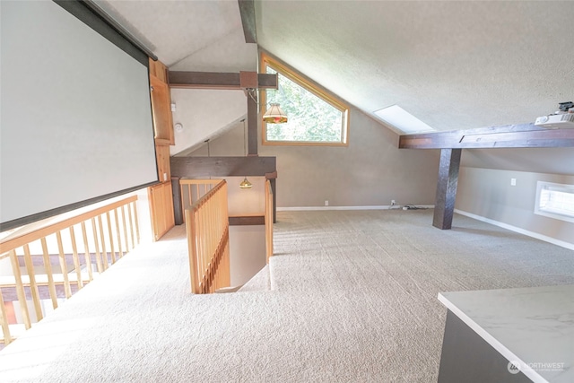 additional living space with light carpet, a textured ceiling, and vaulted ceiling