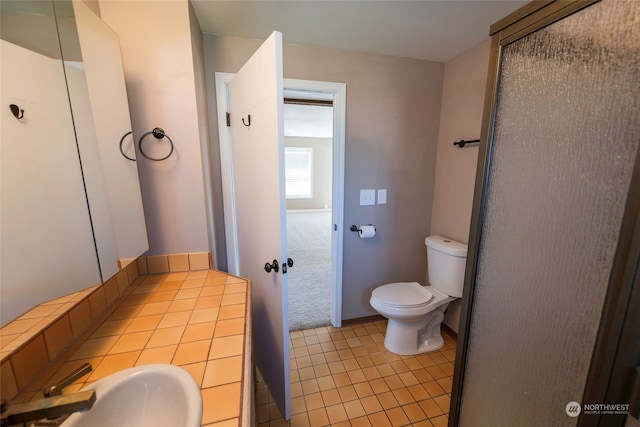 bathroom featuring toilet, sink, and tile patterned floors