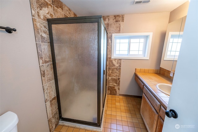 bathroom with vanity, toilet, tile patterned floors, and an enclosed shower