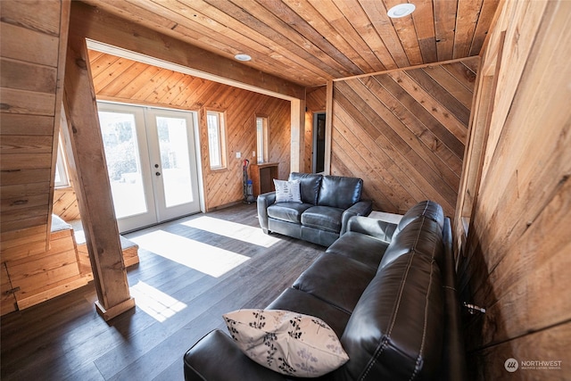 living room featuring wooden walls, wooden ceiling, dark hardwood / wood-style floors, and french doors