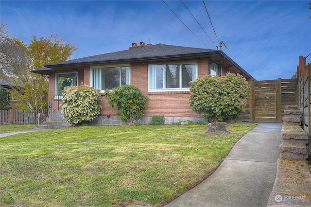 4109 N Huson St, Tacoma, WA 98407 - view of property exterior with a lawn, brick siding, and fence