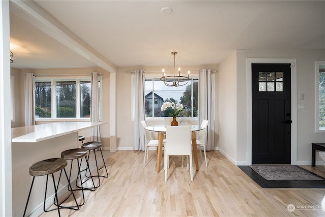 dining space with an inviting chandelier and light wood-type flooring