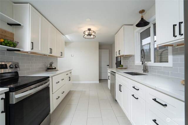 4109 N Huson St, Tacoma, WA 98407 - kitchen featuring a sink, open shelves, stainless steel appliances, baseboards, and backsplash