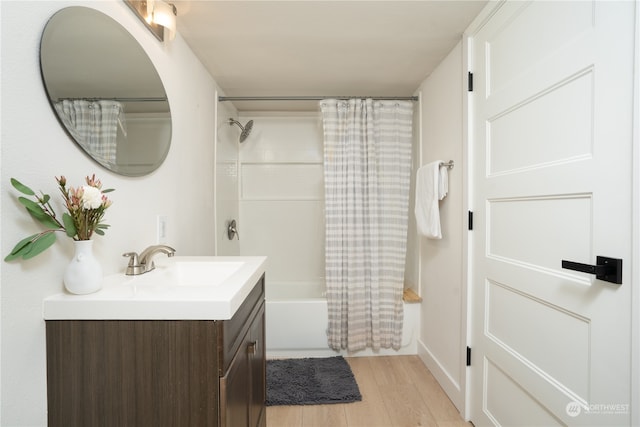 bathroom featuring shower / tub combo with curtain, wood-type flooring, and vanity