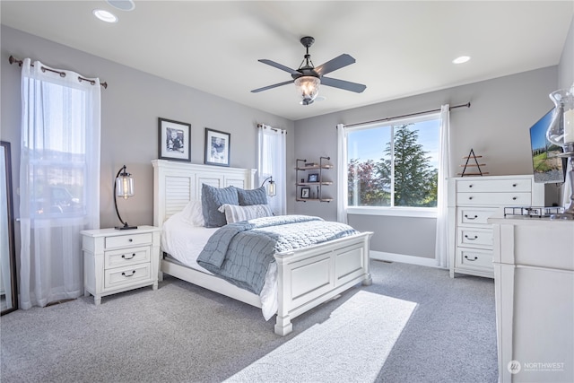 bedroom with ceiling fan and light colored carpet