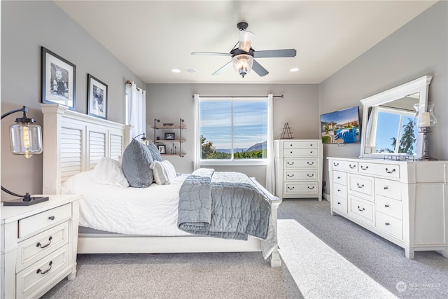 bedroom featuring carpet, multiple windows, and ceiling fan