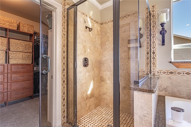 bathroom with tile walls, ornamental molding, and a shower with door