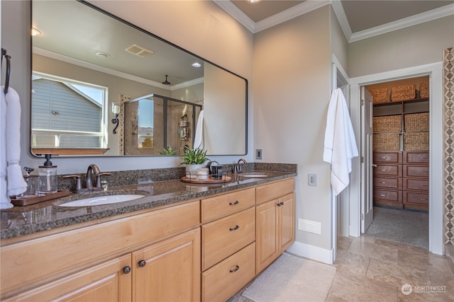 bathroom with ornamental molding, an enclosed shower, and vanity