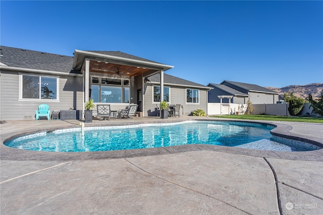 view of pool with ceiling fan and a patio area