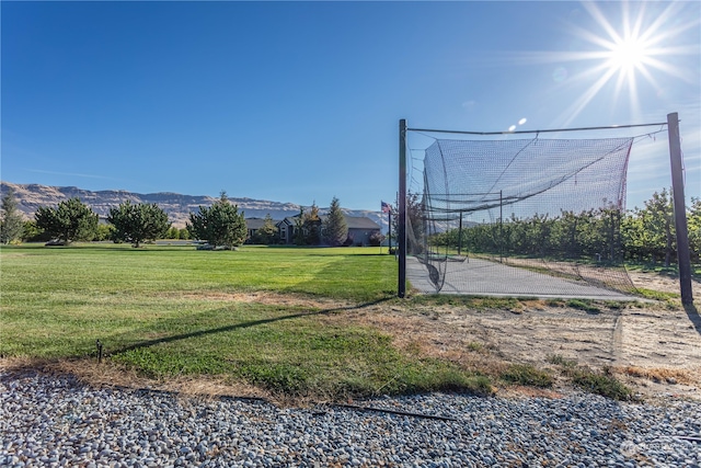 surrounding community with a lawn and a mountain view