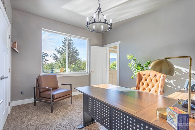 carpeted home office with a notable chandelier