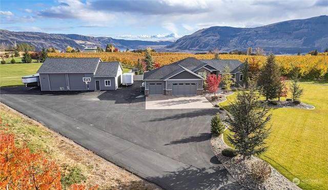 exterior space featuring a front yard and a mountain view