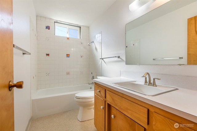 full bathroom with tiled shower / bath combo, vanity, and toilet