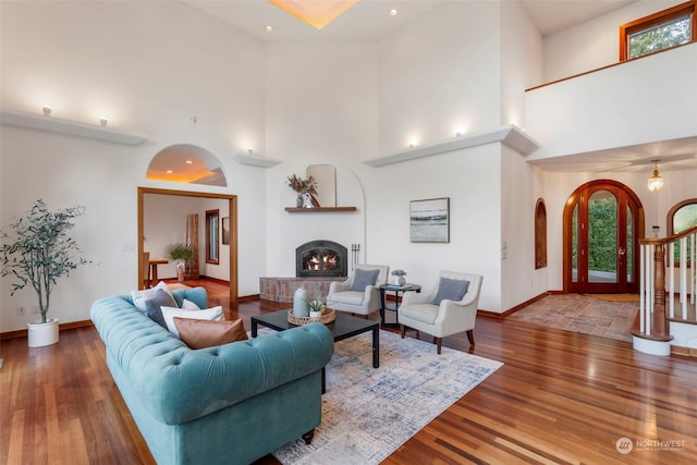 living room featuring hardwood / wood-style floors and high vaulted ceiling