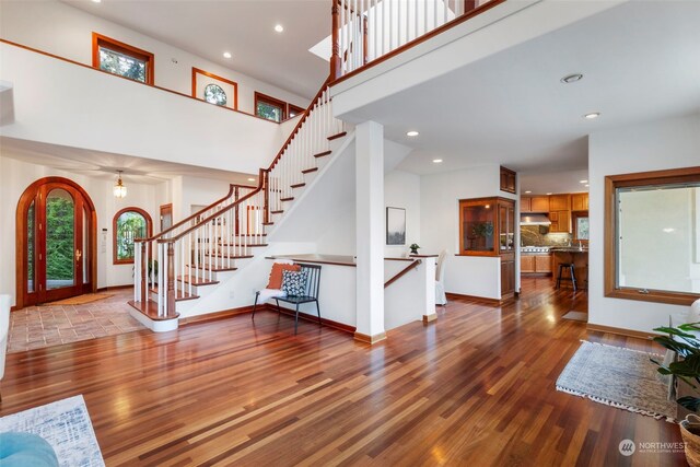 entrance foyer featuring a towering ceiling and light hardwood / wood-style flooring