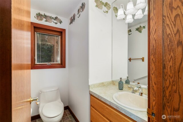 bathroom featuring toilet, vanity, and tile patterned floors