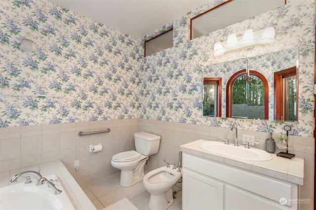 bathroom featuring vanity, a bidet, tile patterned flooring, toilet, and tile walls