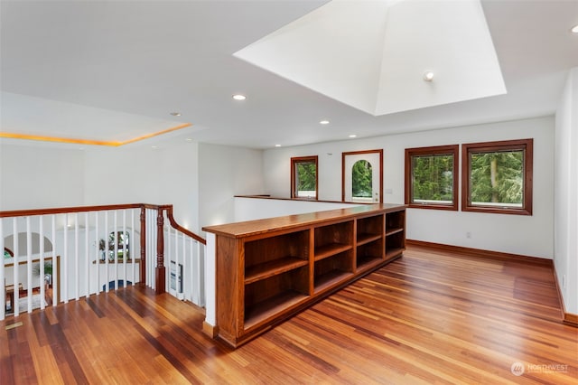 additional living space featuring hardwood / wood-style floors