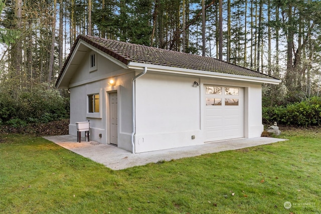 garage featuring a yard