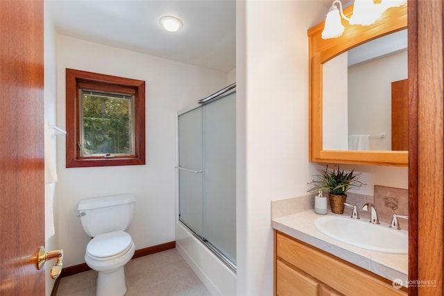 full bathroom with tile patterned floors, vanity, toilet, and shower / bath combination with glass door