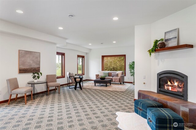 living room with a fireplace and carpet floors