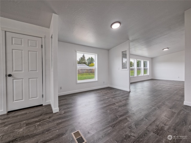 interior space featuring a textured ceiling and dark hardwood / wood-style flooring