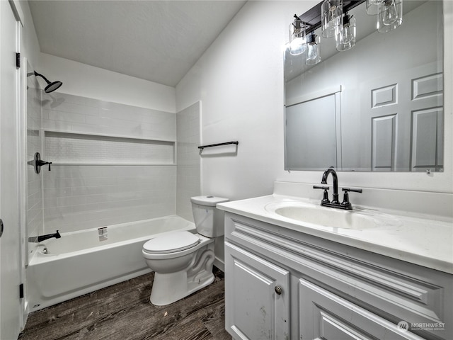 full bathroom with bathing tub / shower combination, hardwood / wood-style flooring, vanity, and toilet