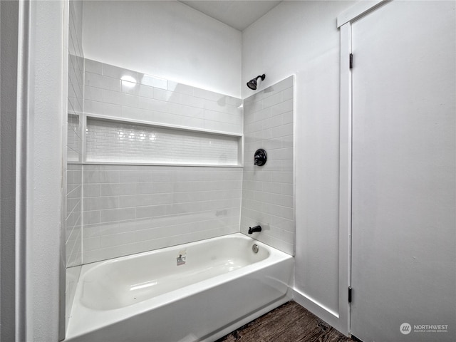 bathroom with tiled shower / bath combo and hardwood / wood-style flooring