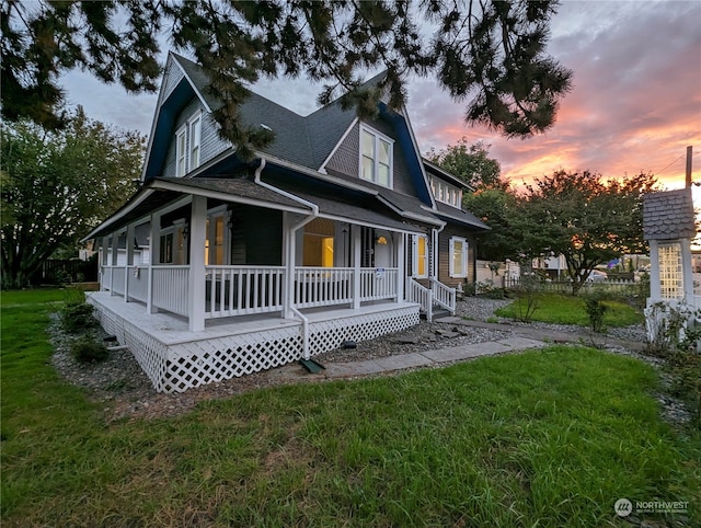 view of front of home with a lawn and covered porch